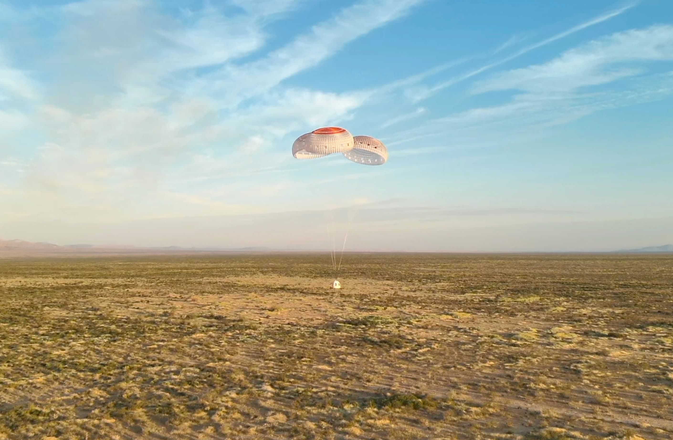 The New Shepard crew capsule descends under parachutes during NS-35.